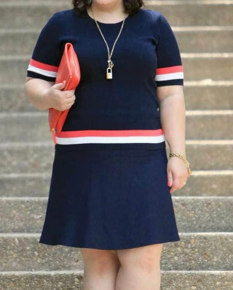 Cabi Hampton Shell Knit Top, is Navy with red and White Stripe at Sleeve and Hem.